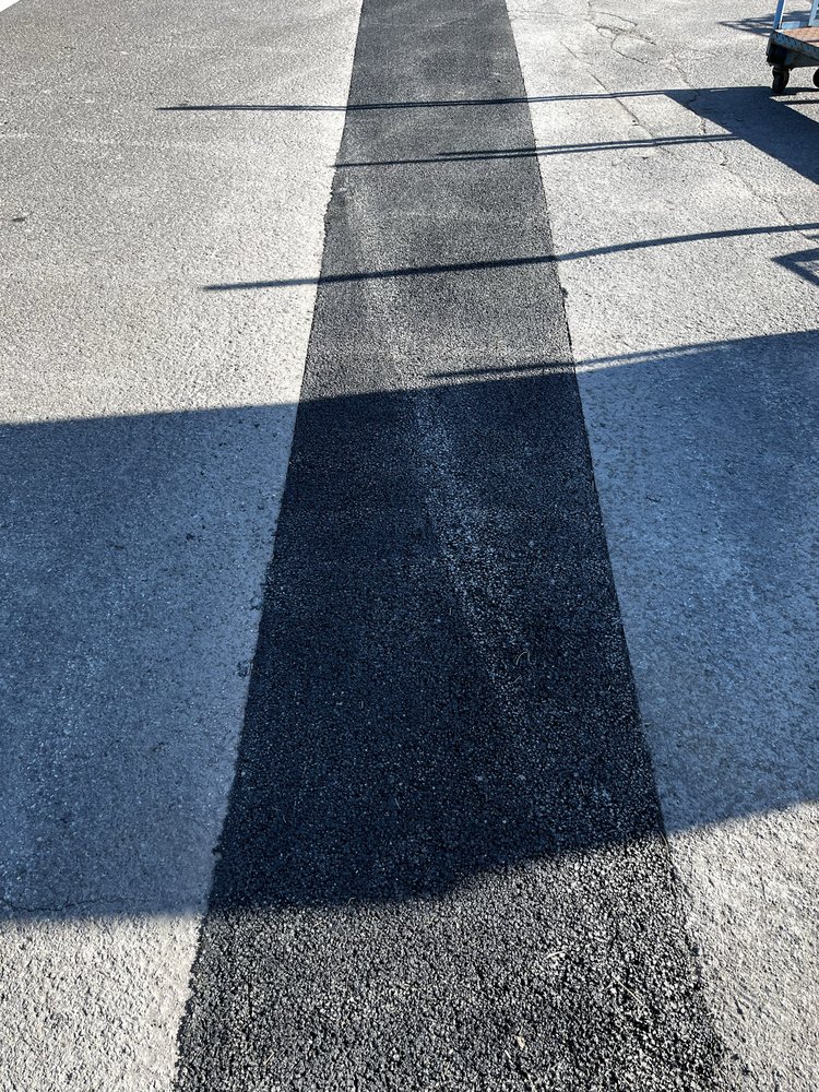 Shadow cast on textured concrete surface with varying gray and blue tones